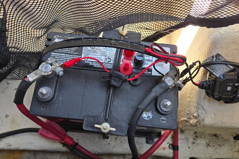 Slide: The Image of Battery setup in a 2015 Regal 1900 Bowrider boat with connected cables. - 27