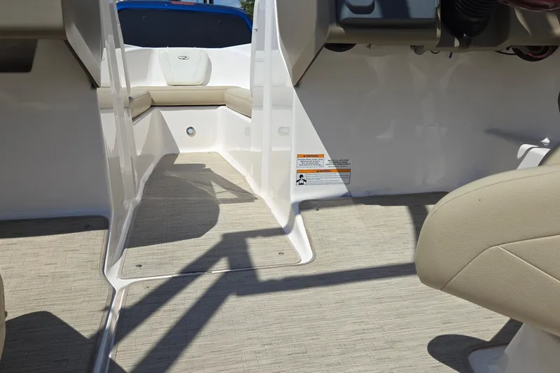 Slide: The Image of 2015 Regal 1900 Bowrider interior with beige seating and carpeted flooring. - 29