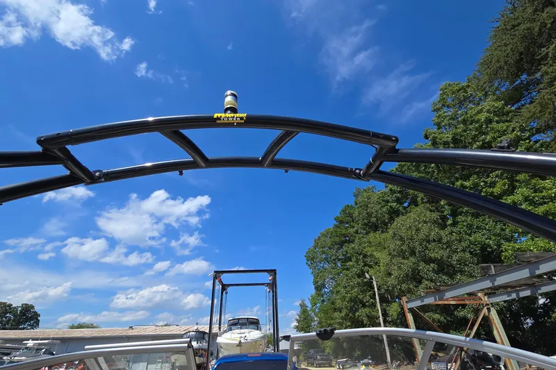 Slide: The Image of 2015 Regal 1900 Bowrider with wakeboard tower under clear blue sky. - 31