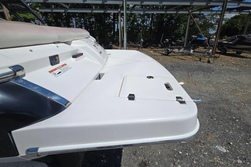 Slide: The Image of 2015 Regal 1900 Bowrider boat stern view with swim platform in outdoor setting. - 6