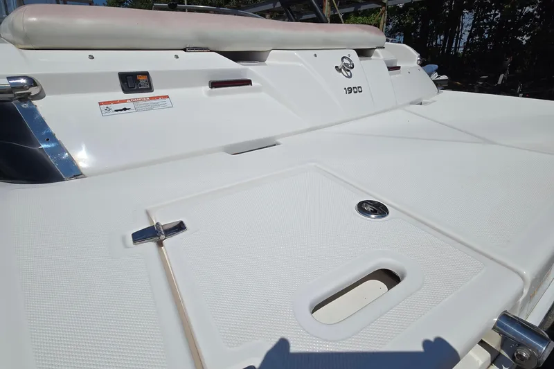 Slide: The Image of 2015 Regal 1900 Bowrider boat deck, featuring sleek white design and safety features. - 8