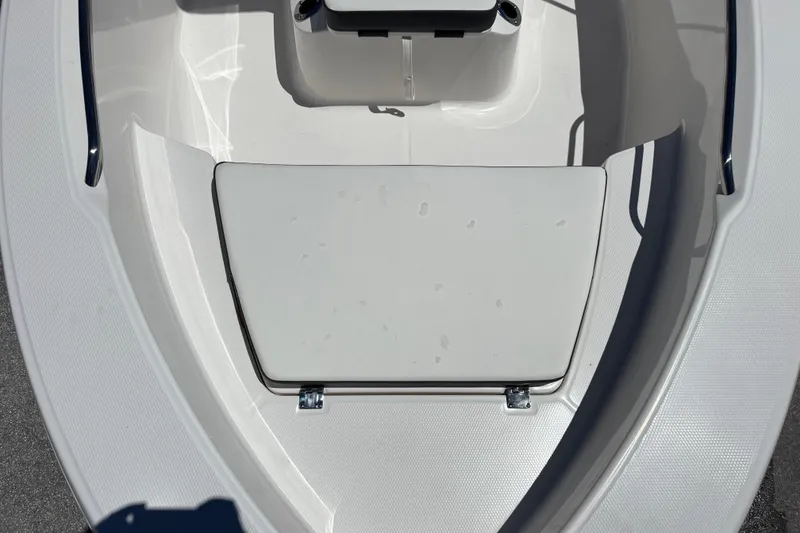 Slide: The Image of 2025 Robalo R160 Center Console boat interior with white seating and storage area. - 11