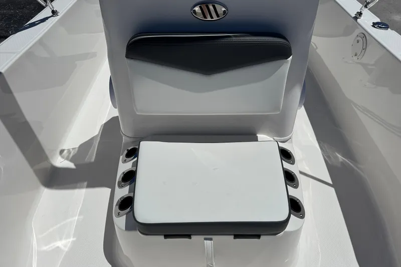 Slide: The Image of 2025 Robalo R160 Center Console boat seat with rod holders, white and gray design. - 13