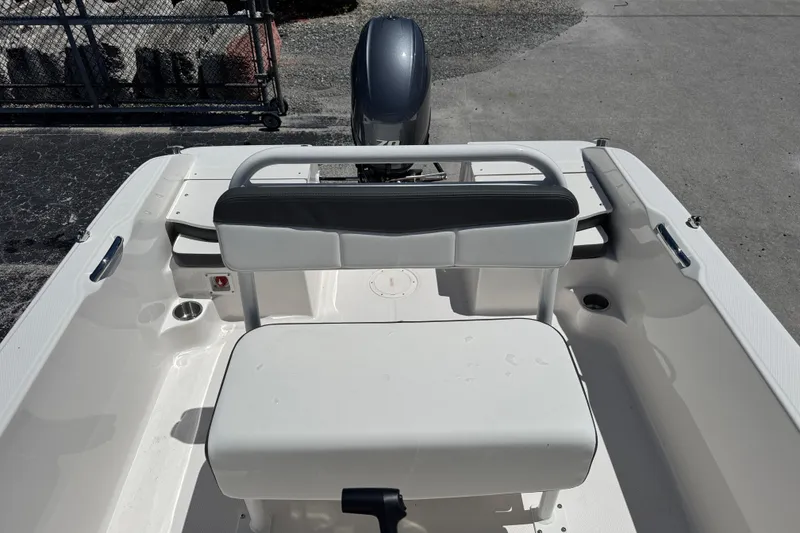 Slide: The Image of 2025 Robalo R160 Center Console boat interior with seating and motor view. - 14