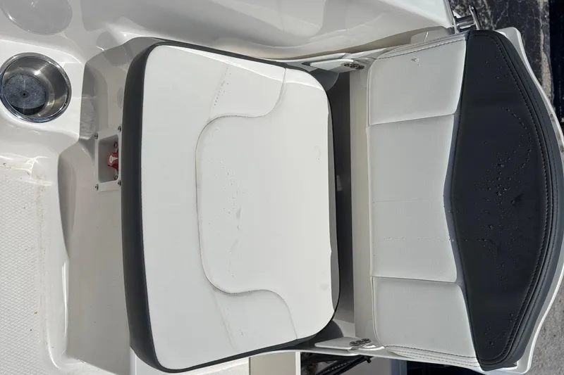 Slide: The Image of 2025 Robalo R160 Center Console boat seat with white and black cushioned design. - 16