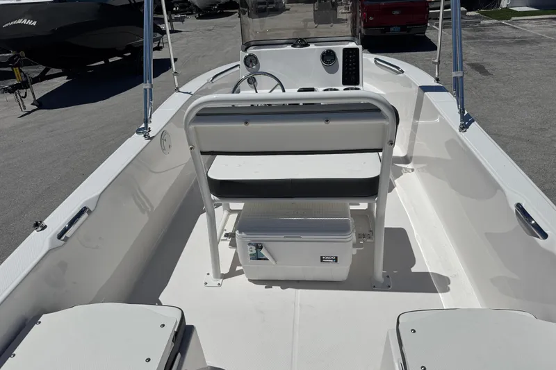 Slide: The Image of 2025 Robalo R160 Center Console boat interior with seating and cooler. - 6
