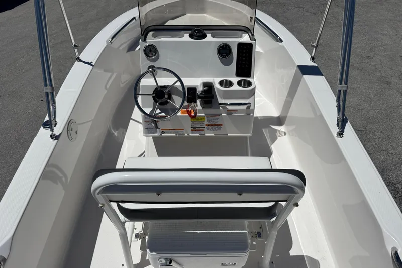 Slide: The Image of 2025 Robalo R160 Center Console boat interior with steering wheel and seating. - 7
