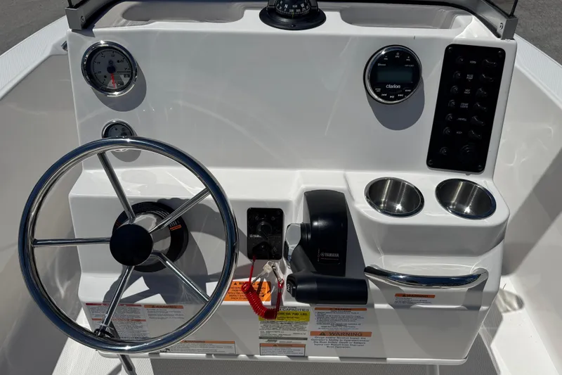 Slide: The Image of 2025 Robalo R160 Center Console boat dashboard with steering wheel and controls. - 8