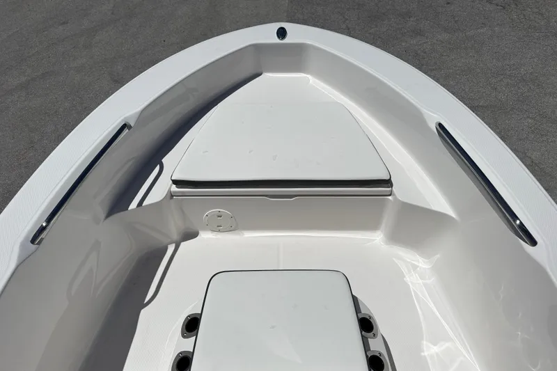 Slide: The Image of 2025 Robalo R160 Center Console boat interior, featuring sleek white seating and storage compartments. - 9
