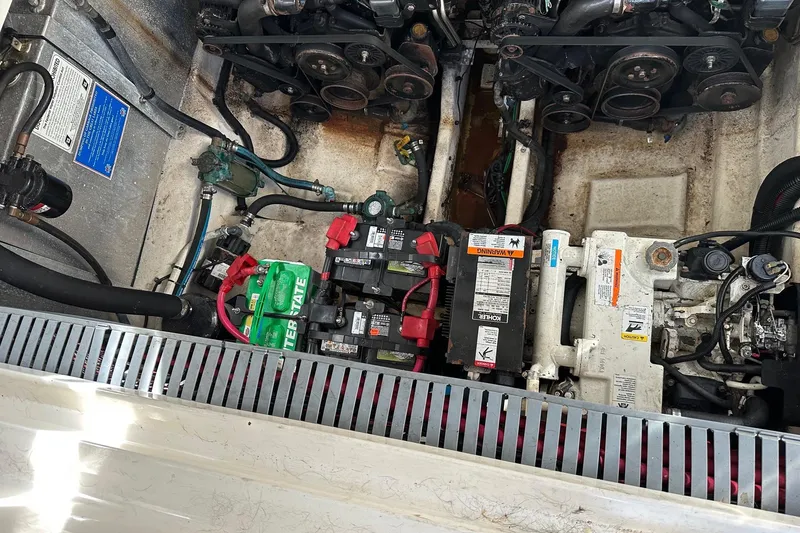 Slide: The Image of Engine compartment of a 2005 Sea Ray 300 Sundancer with visible batteries and components. - 11