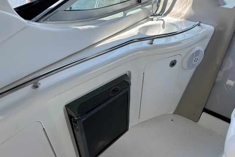 Slide: The Image of 2005 Sea Ray 300 Sundancer boat interior with sink and storage area. - 12