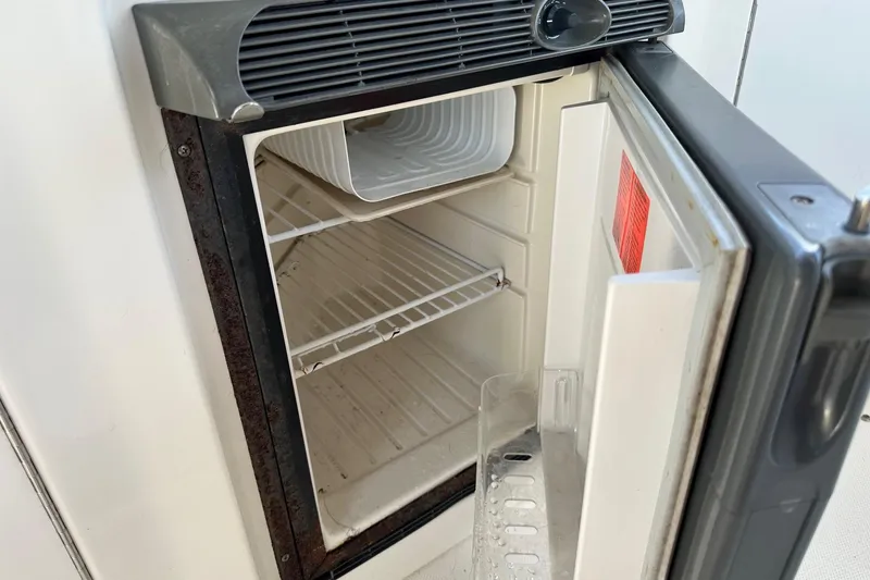 Slide: The Image of Open refrigerator inside a 2005 Sea Ray 300 Sundancer boat. - 13