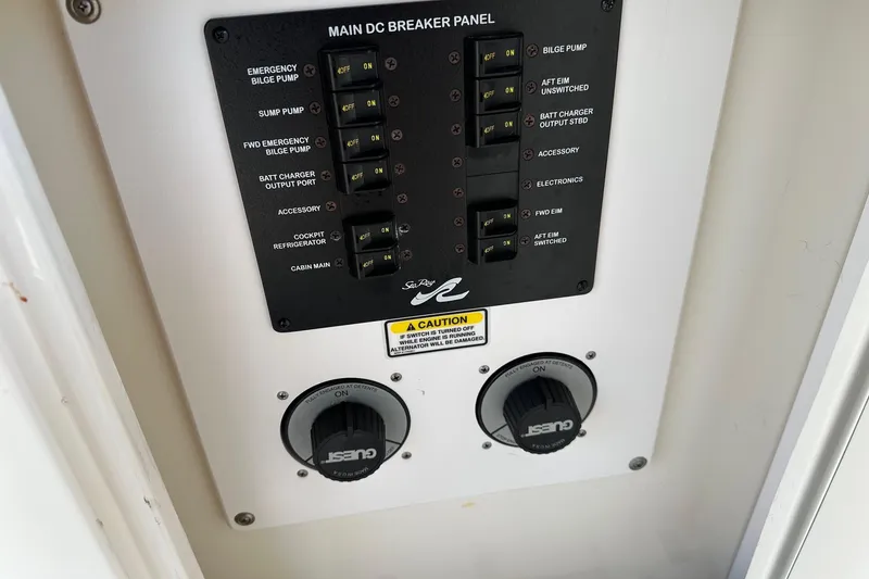Slide: The Image of Main DC breaker panel on 2005 Sea Ray 300 Sundancer boat, featuring various switches and controls. - 14