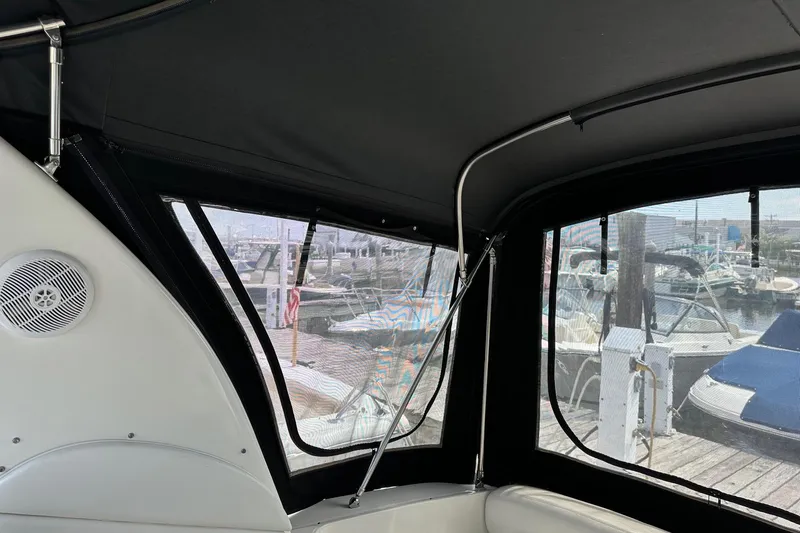 Slide: The Image of Interior view of 2005 Sea Ray 300 Sundancer with marina backdrop. - 20