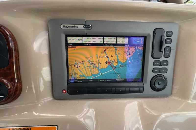 Slide: The Image of Raymarine C90W navigation system on 2005 Sea Ray 300 Sundancer boat dashboard. - 23