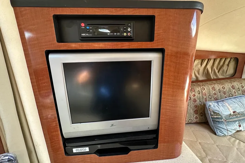 Slide: The Image of 2005 Sea Ray 300 Sundancer cabin with built-in TV and DVD player. - 26