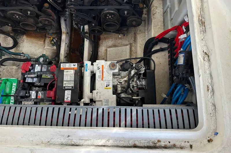 Slide: The Image of Engine compartment of a 2005 Sea Ray 300 Sundancer with batteries and mechanical components. - 8