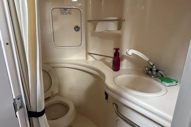 Slide: The Image of Compact bathroom in 2005 Sea Ray 300 Sundancer boat with toilet, sink, and shower. - 9