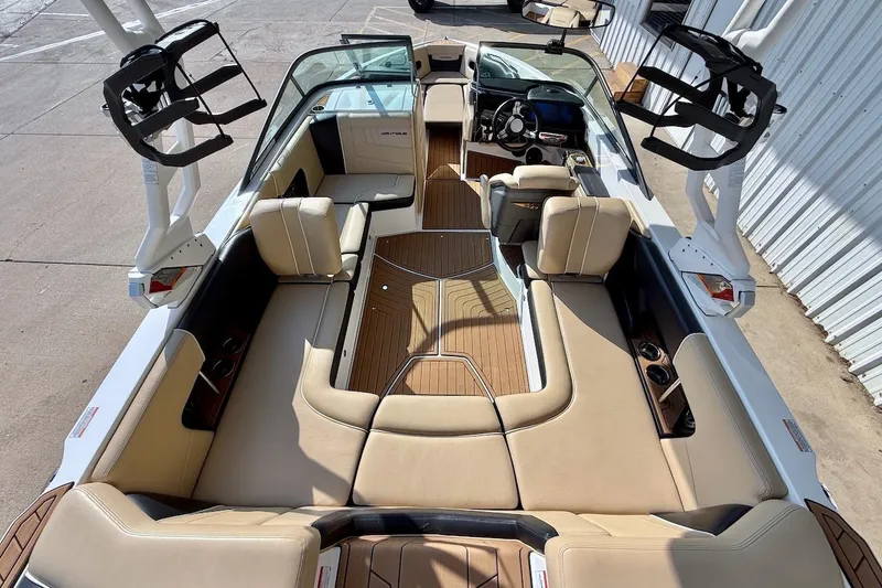 Slide: The Image of 2020 Nautique Super Air Nautique 230 interior with tan seating and sleek design. - 13