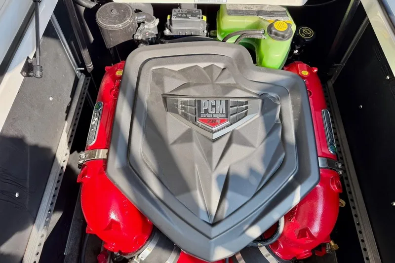 Slide: The Image of Engine of 2020 Nautique Super Air Nautique 230 with PCM cover and red components. - 18