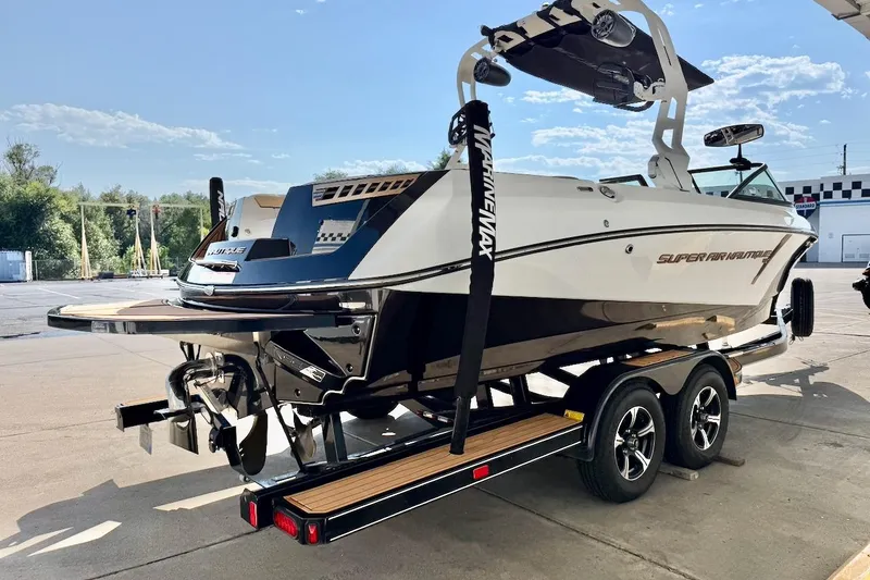 Slide: The Image of 2020 Nautique Super Air Nautique 230 boat on trailer, sleek design, sunny day. - 7