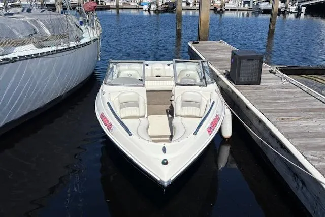 Slide: The Image of 2008 Stingray 185 LX boat docked at marina, featuring sleek design and comfortable seating. - 1