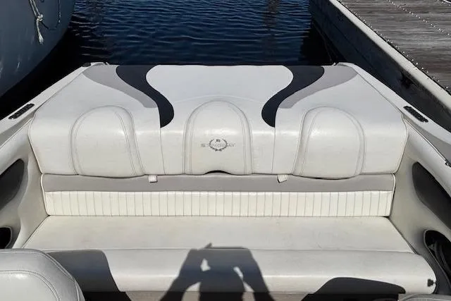 Slide: The Image of 2008 Stingray 185 LX boat interior with white seating, docked by the water. - 11