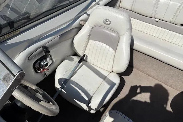 Slide: The Image of 2008 Stingray 185 LX boat interior with white seating and steering wheel. - 13
