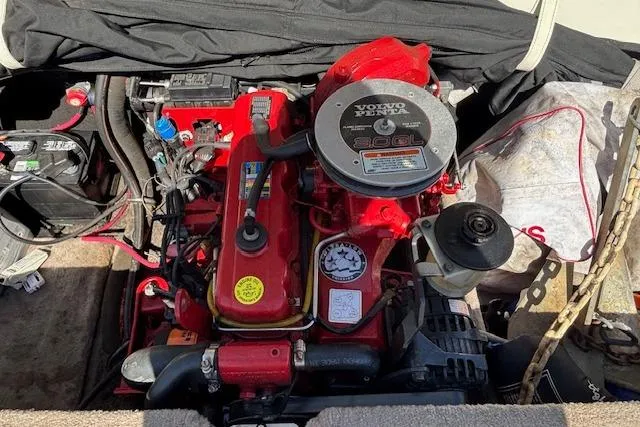 Slide: The Image of 2008 Stingray 185 LX boat engine, featuring a Volvo Penta motor, in a maintenance setting. - 16