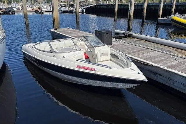 Slide: The Image of 2008 Stingray 185 LX boat docked at marina, featuring sleek design and spacious seating. - 2