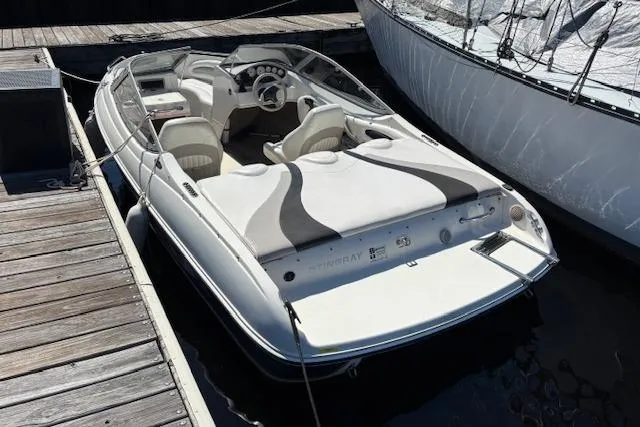 Slide: The Image of 2008 Stingray 185 LX boat docked, featuring sleek design and spacious seating. - 4
