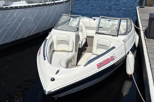 Slide: The Image of 2008 Stingray 185 LX boat docked on calm water, featuring white seating and sleek design. - 5