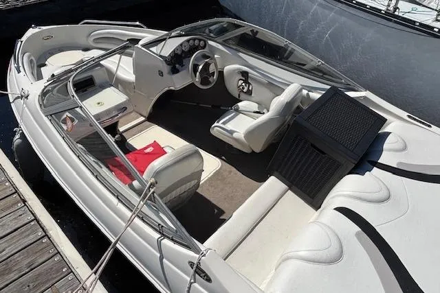 Slide: The Image of 2008 Stingray 185 LX boat with white interior, docked at a marina. - 7