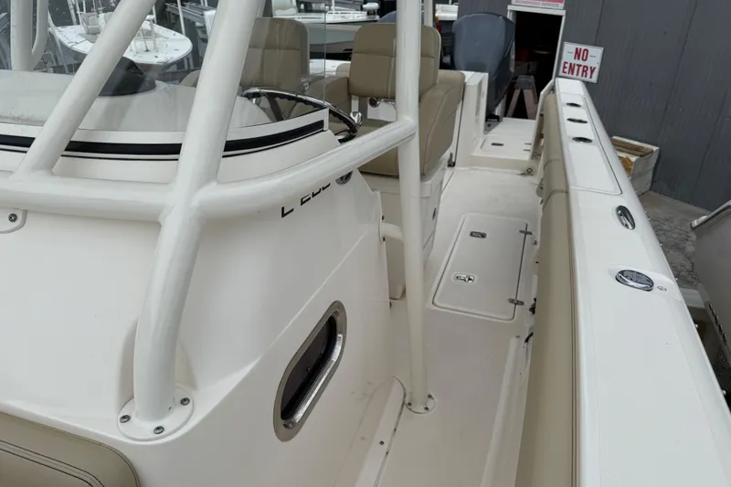 Slide: The Image of 2016 Pursuit C 280 Center Console boat interior with seating and storage compartments. - 13