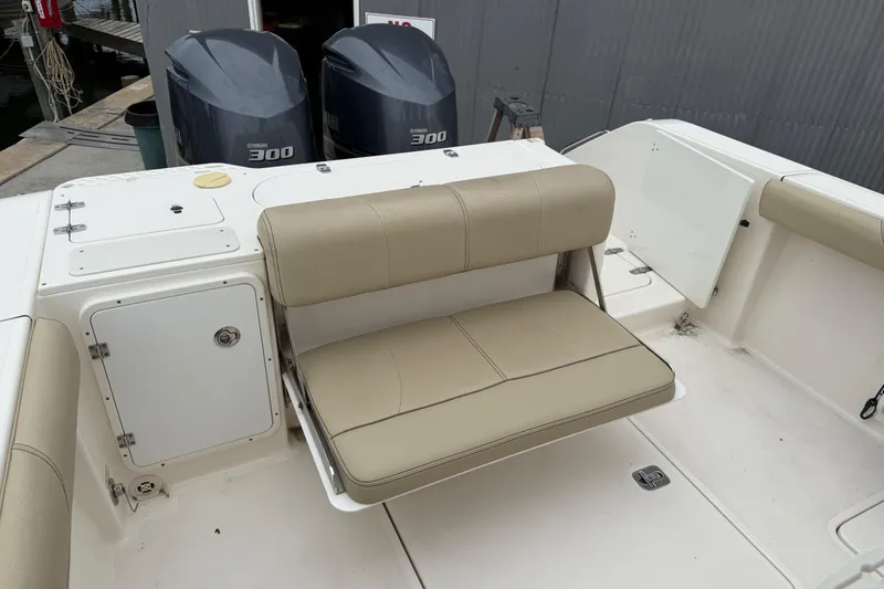 Slide: The Image of 2016 Pursuit C 280 Center Console boat with beige seating and twin Yamaha 300 engines. - 19