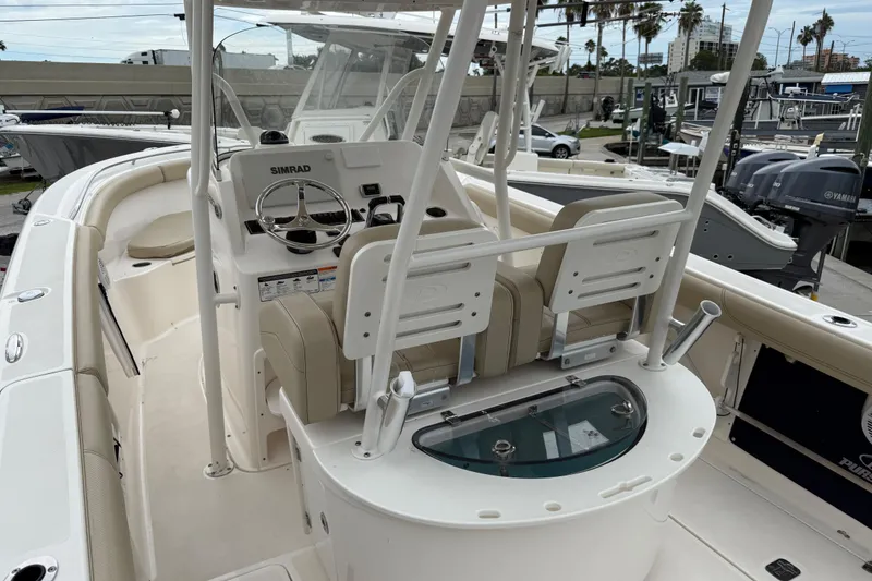 Slide: The Image of 2016 Pursuit C 280 Center Console boat interior with helm and seating area. - 2