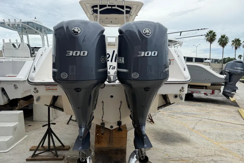 Slide: The Image of 2016 Pursuit C 280 Center Console with twin Yamaha 300 engines at a marina. - 21