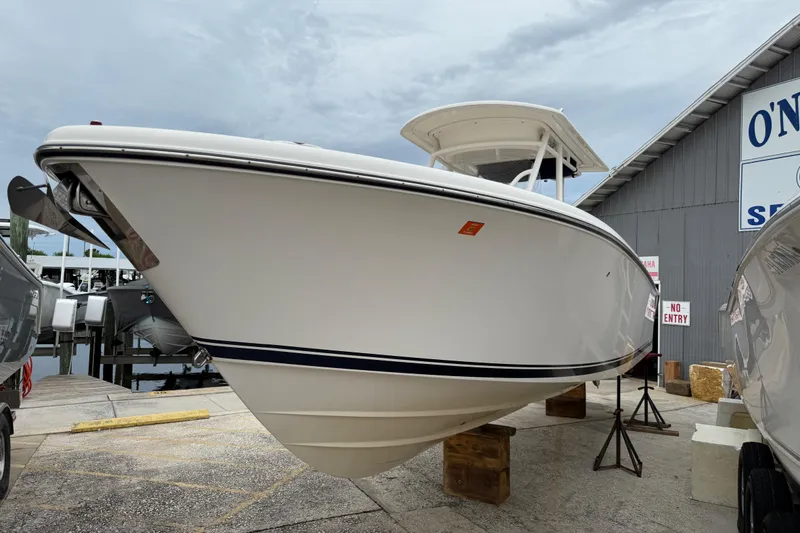Slide: The Image of 2016 Pursuit C 280 Center Console boat displayed at a marina, side view. - 23