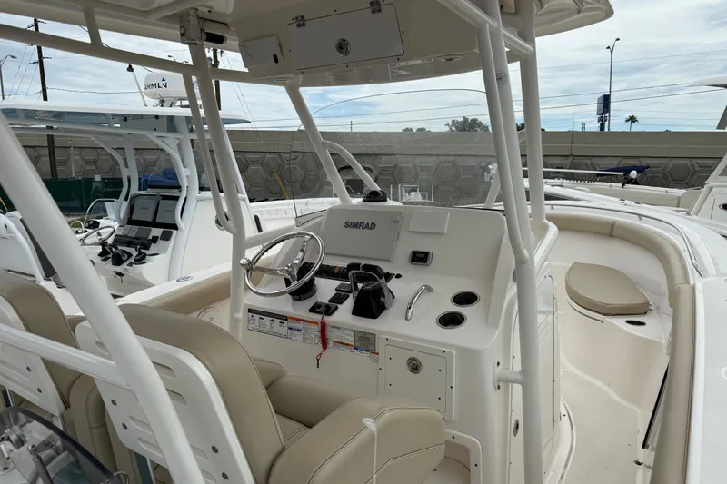 Slide: The Image of 2016 Pursuit C 280 Center Console boat interior with steering wheel and seating. - 4