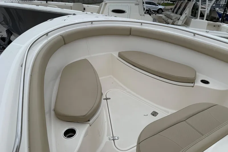 Slide: The Image of 2016 Pursuit C 280 Center Console boat interior with beige seating. - 8