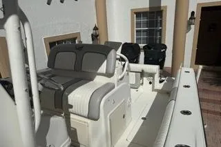 Slide: The Image of 2015 Mako 284 Center Console boat with dual seating and modern design. - 11