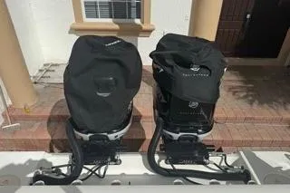 Slide: The Image of 2015 Mako 284 Center Console with dual covered outboard motors. - 12