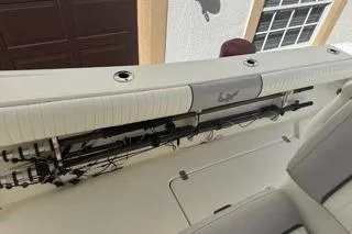 Slide: The Image of 2015 Mako 284 Center Console boat interior with rod storage. - 14