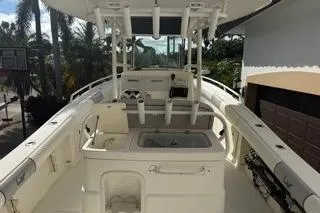 Slide: The Image of 2015 Mako 284 Center Console boat with fishing rod holders and spacious deck. - 18