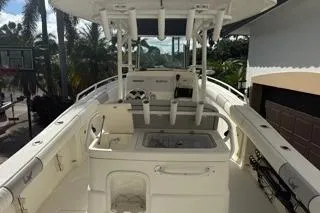 Slide: The Image of 2015 Mako 284 Center Console boat with fishing rod holders and spacious deck. - 19