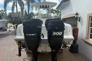 Slide: The Image of 2015 Mako 284 Center Console boat with twin 300 horsepower engines, parked outdoors. - 21