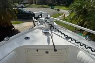 Slide: The Image of 2015 Mako 284 Center Console boat bow with trolling motor in a residential area. - 7
