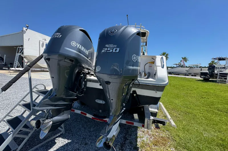 Slide: The Image of 2015 Pursuit OS 285 Offshore boat with twin Yamaha 250 engines on a trailer. - 14
