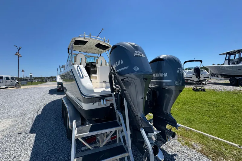 Slide: The Image of 2015 Pursuit OS 285 Offshore boat with twin Yamaha 250 engines on a trailer. - 16