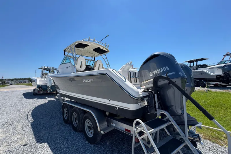 Slide: The Image of 2015 Pursuit OS 285 Offshore boat with Yamaha engine on trailer, sunny day. - 17